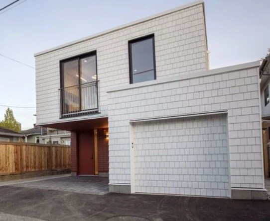 Laneway / Infill house done for Saint Group in the Vancouver area. This infill house has Tyvek as a weather barrier covered with 2" semirigid insulation Roxul Comfortboard. Vertical 1x4 treated strapping was used over the insulation. 3 sides of the house are covered with horizontal pressure-treated strapping as an attachment layer for Cedar Shingles. The west side of the house is covered with Hardie Shingle panels as a requirement for fire safety. We have also prepared a board for a beautiful soffit over the entrance covered with tiles.