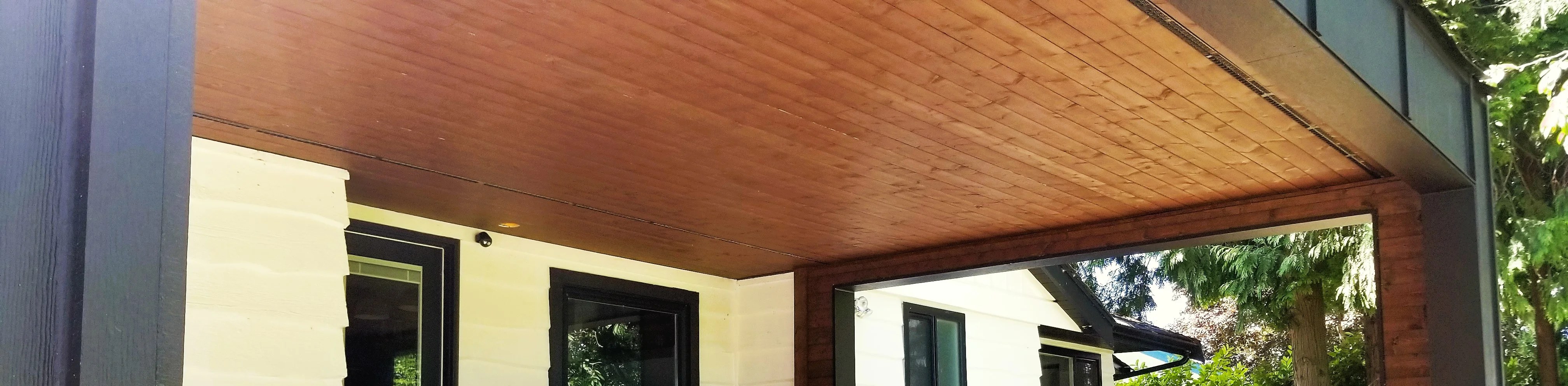 Siding installation for homeowners at Ladner. 1x4 wooden soffit and Hardie board and Batten around columns and fascia.