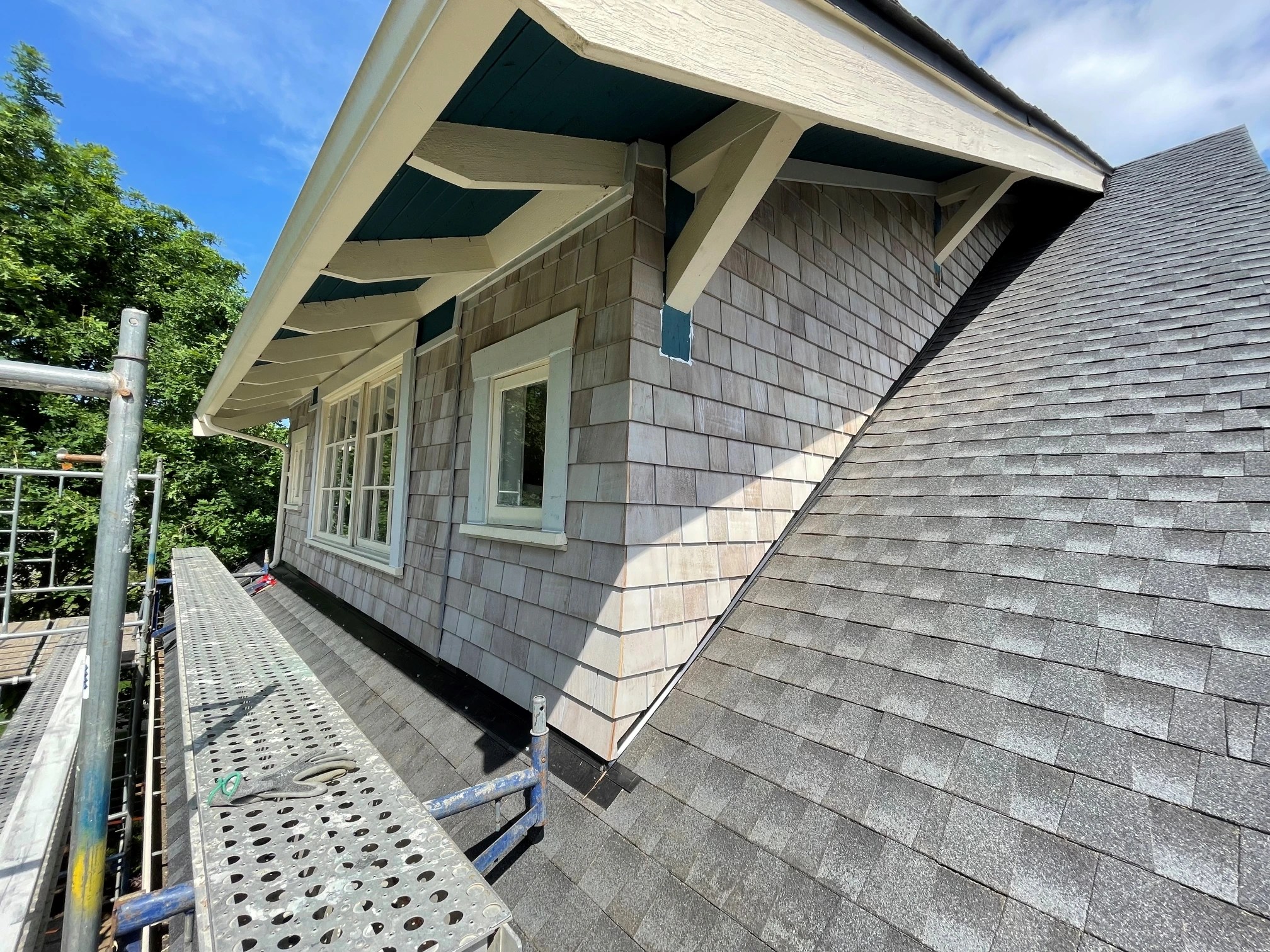 Cedar Shakes replacement was done for the homeowners. A customer called us after the roof has been fixed with a poor visual result and asked us if we can fix it. Yes, we can. The biggest challenge was accessing the area. We made it. Cedar shingles around the dorm are ready for spring painting.