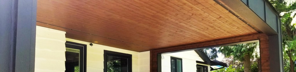 Siding installation for homeowners at Ladner. 1x4 wooden soffit and Hardie board and Batten around columns and fascia.