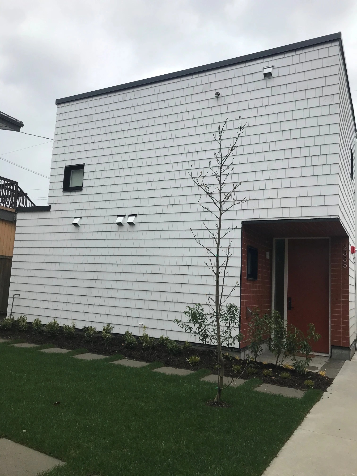 Laneway / Infill house done for Saint Group in the Vancouver area. This infill house has Tyvek as a weather barrier covered with 2" semirigid insulation Roxul Comfortboard. Vertical 1x4 treated strapping was used over the insulation. 3 sides of the house are covered with horizontal pressure-treated strapping as an attachment layer for Cedar Shingles. The west side of the house is covered with Hardie Shingle panels as a requirement for fire safety. We have also prepared a board for a beautiful soffit over the entrance covered with tiles.