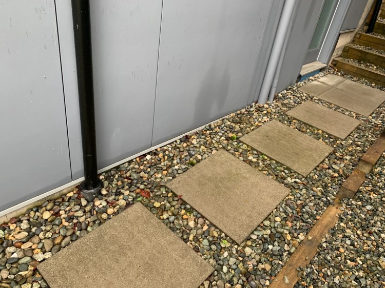 Bottom of siding burried in the gravel.